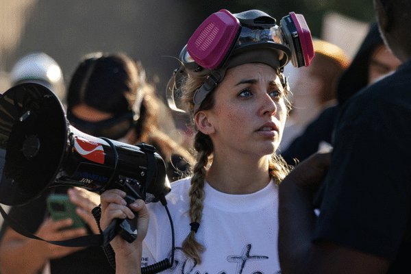 A Democratic candidate from 'Gen Z' who is accused of obstructing ICE agents shared a video showing herself participating in a crowd that blocked an unmarked SUV.