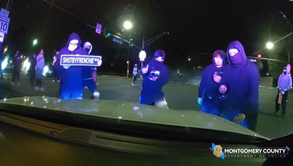 Wild video shows masked ruffians attacking police cruiser with officer inside during illegal street takeover