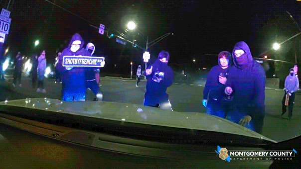 Wild video shows masked ruffians attacking police cruiser with officer inside during illegal street takeover